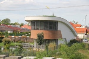 Modern house with grass roof & in water garden